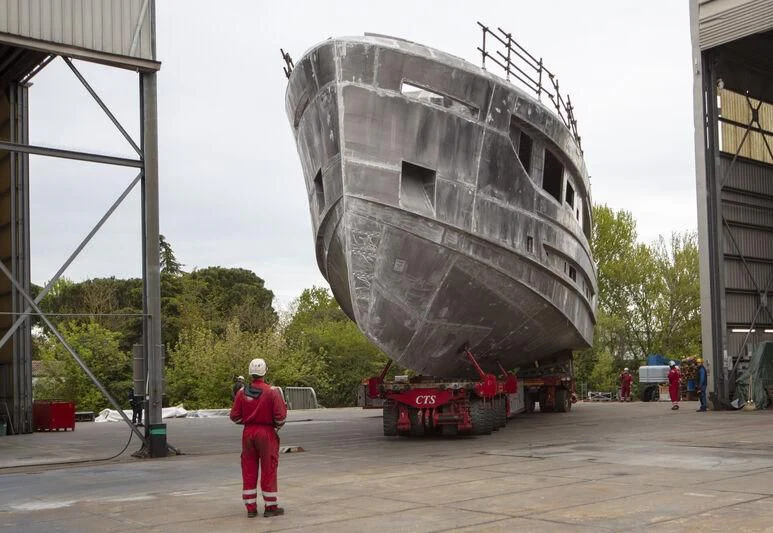 a person in a helmet standing next to a large metal object aboard VITTORIA VELOCE 32 RPH #01 Yacht for Sale