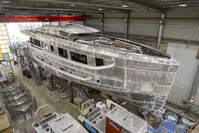 a large white ship in a warehouse aboard VITTORIA VELOCE 32 RPH #01 Yacht for Sale