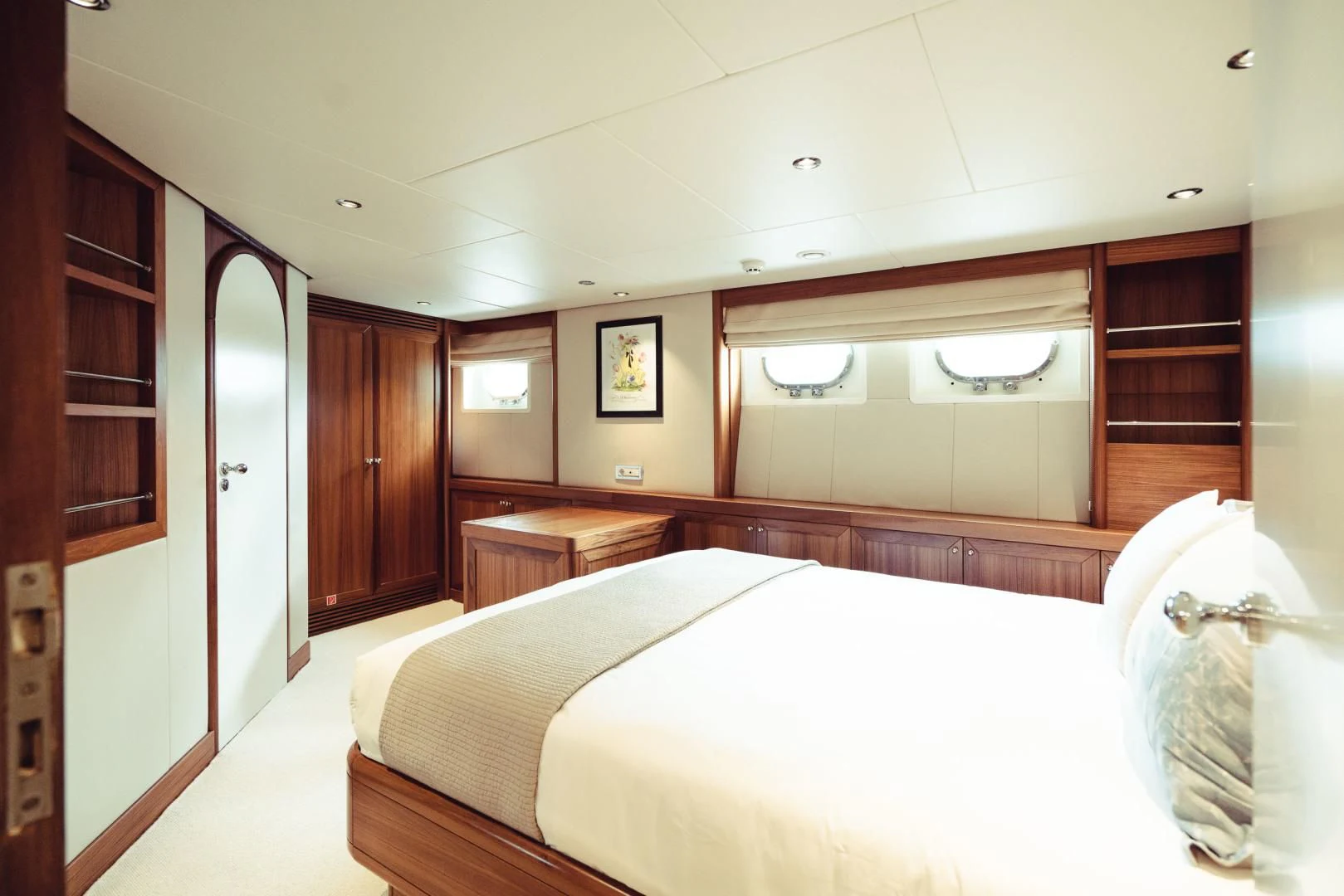 a room with a bed and a mirror aboard WIZARD ONE Yacht for Sale