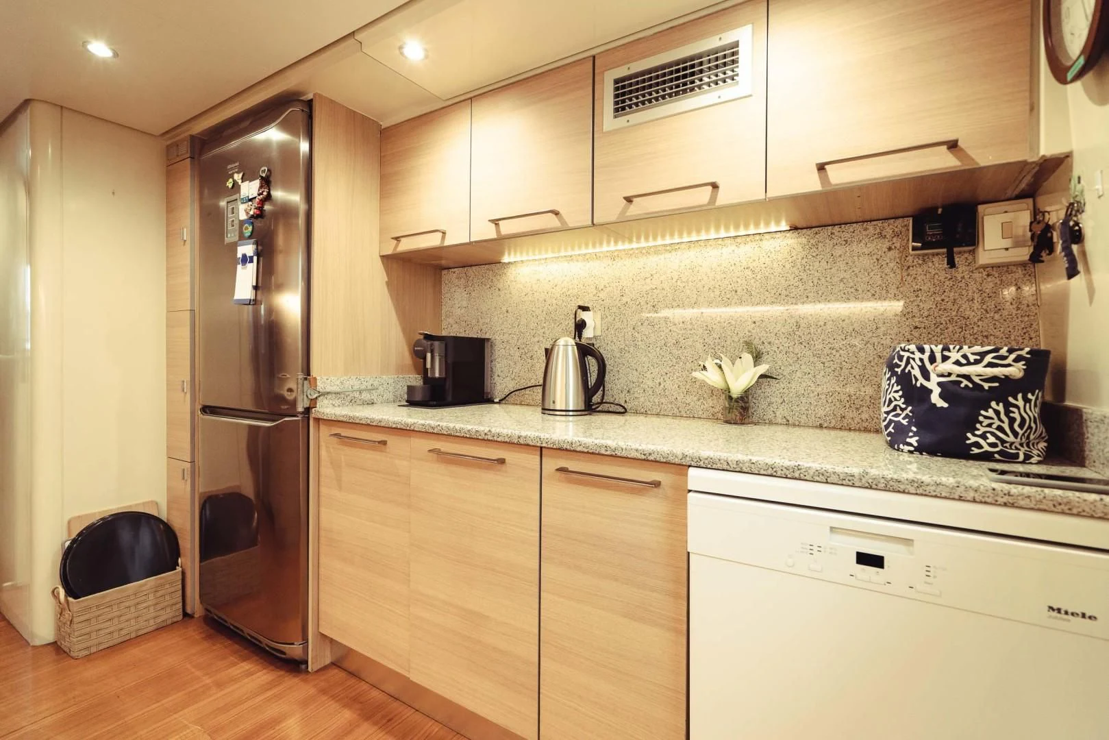 a kitchen with a stainless steel refrigerator aboard WIZARD ONE Yacht for Sale