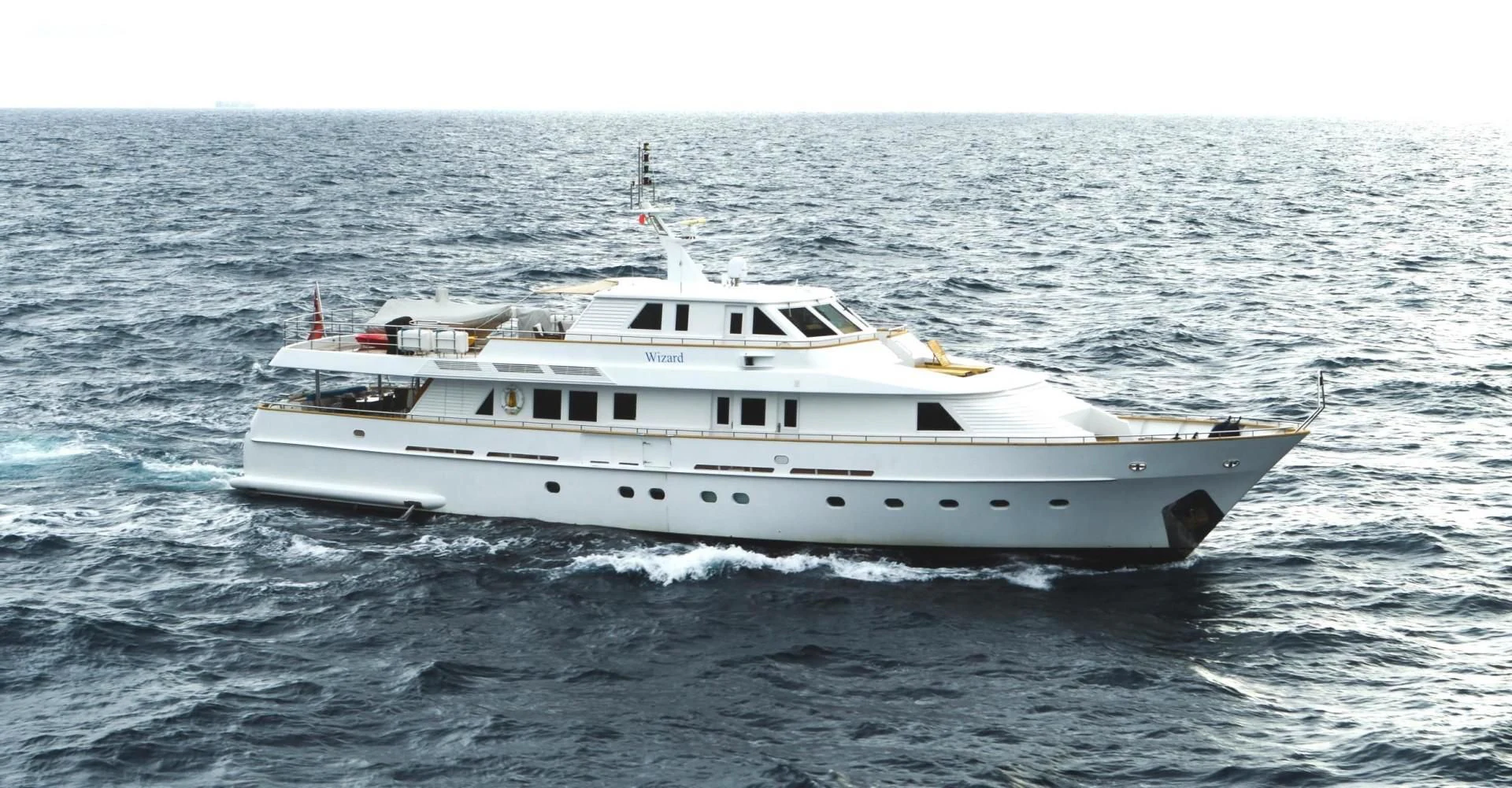 a white boat in the water aboard WIZARD ONE Yacht for Sale