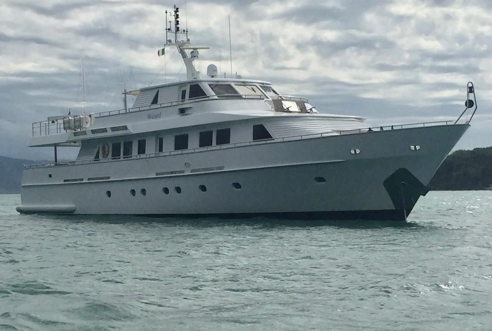 a large white ship in the water aboard WIZARD ONE Yacht for Sale