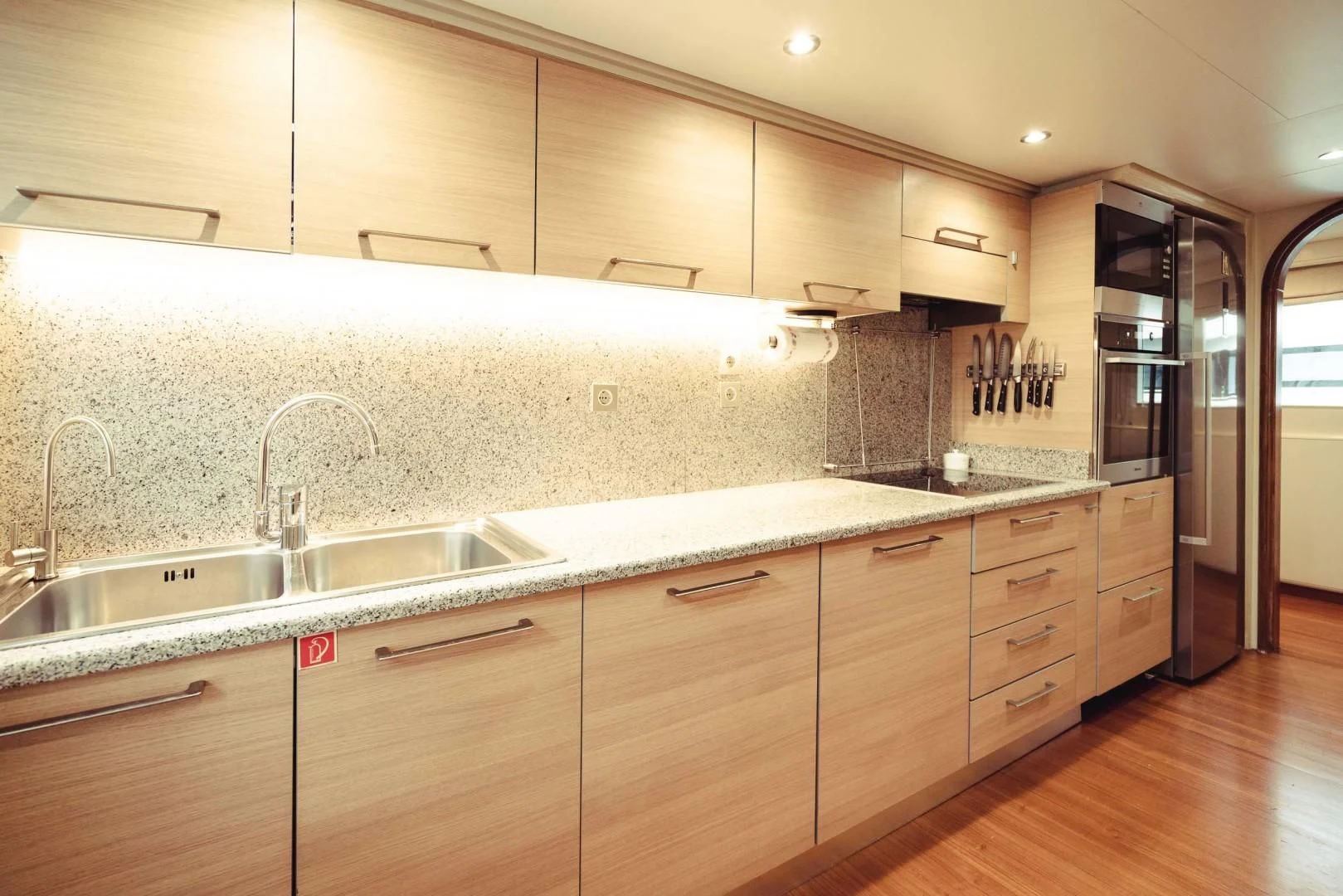 a kitchen with wooden cabinets aboard WIZARD ONE Yacht for Sale