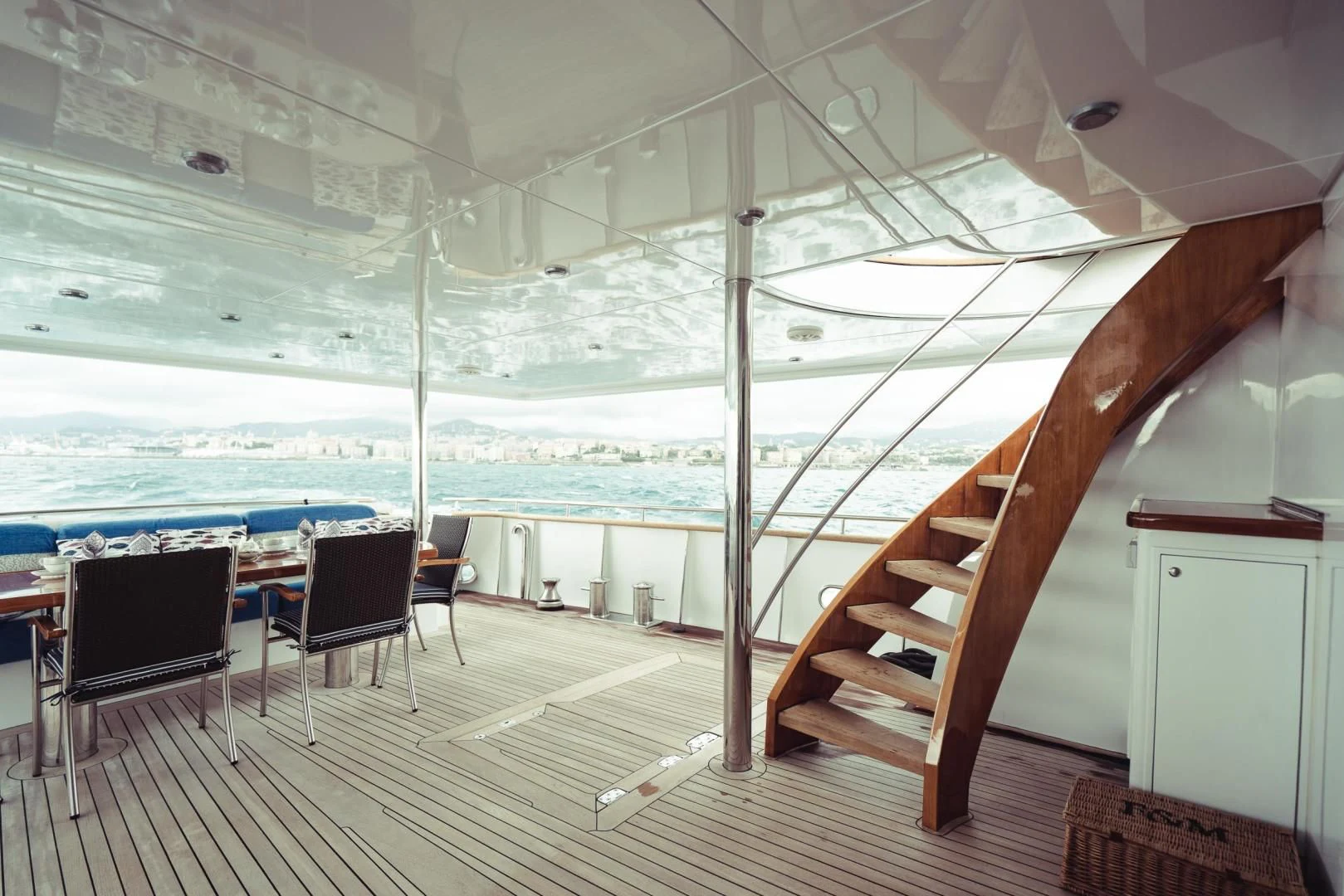 a wood staircase leading to a balcony aboard WIZARD ONE Yacht for Sale