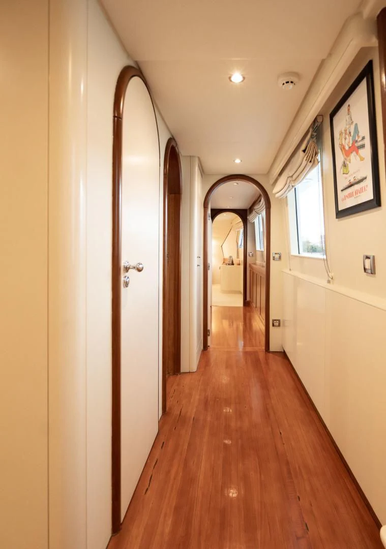 a hallway with a wood floor and doors aboard WIZARD ONE Yacht for Sale