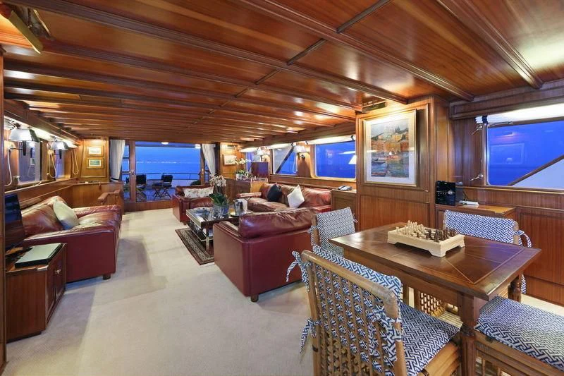 a living room with a table and chairs aboard RA Yacht for Sale