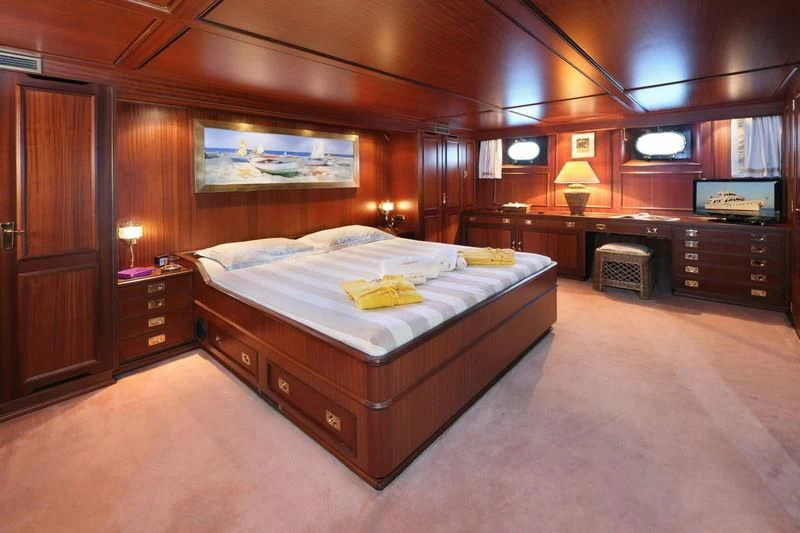 a large bedroom with a large bed aboard RA Yacht for Sale