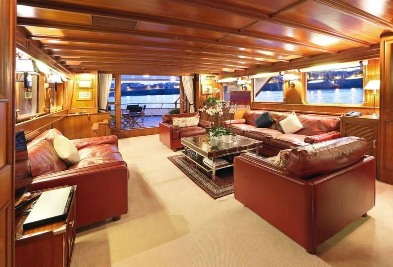 a living room with a couch and a table aboard RA Yacht for Sale