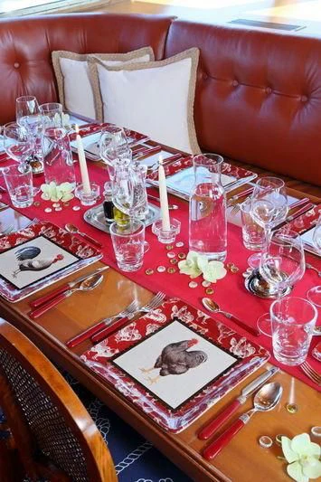 a table with a plate and glasses aboard RA Yacht for Sale