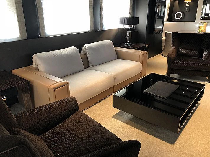 a living room with a couch and a coffee table aboard RA Yacht for Sale