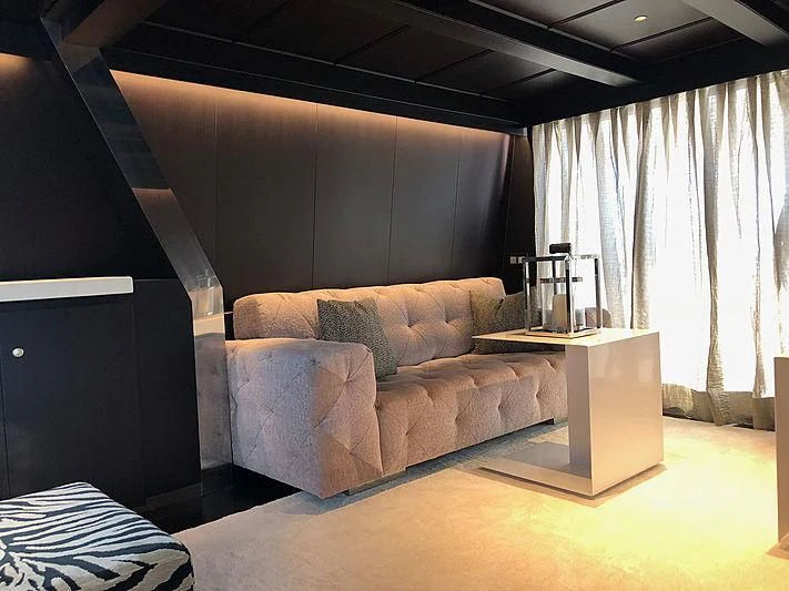 a couch in a room aboard RA Yacht for Sale