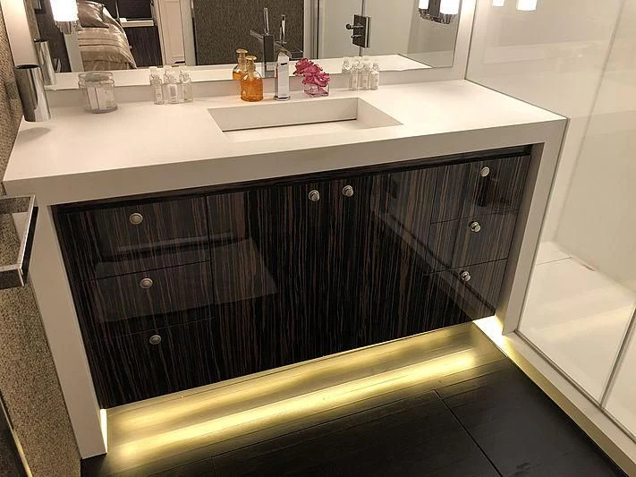 a bathroom sink with a black countertop aboard RA Yacht for Sale