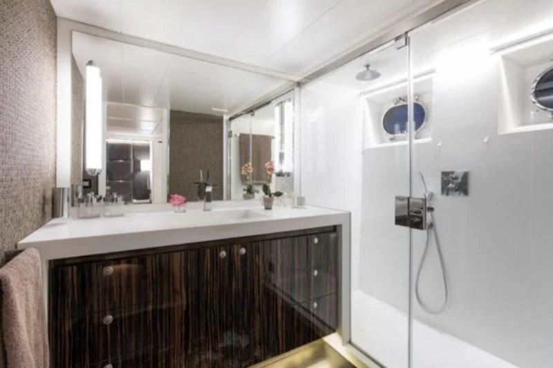 a bathroom with a large mirror aboard RA Yacht for Sale