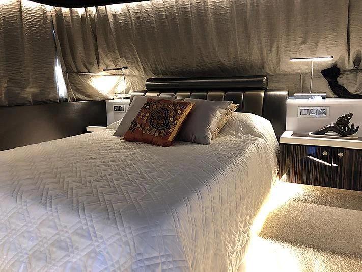 a bed with a pillow and a pillow on it aboard RA Yacht for Sale