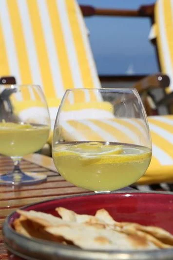 a plate of food and a glass of liquid aboard RA Yacht for Sale
