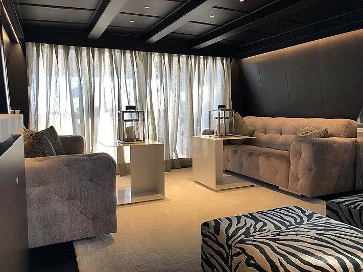 a living room with a couch and a tv aboard RA Yacht for Sale