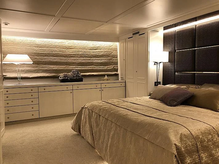 a bedroom with a large bed aboard RA Yacht for Sale