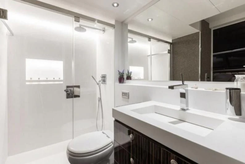 a bathroom with a glass shower aboard RA Yacht for Sale