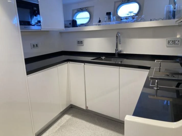 a kitchen with a large mirror aboard RA Yacht for Sale