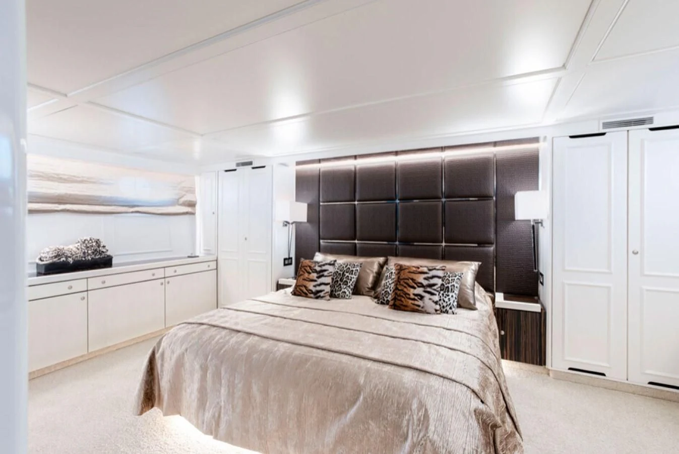 a bedroom with a large bed aboard RA Yacht for Sale