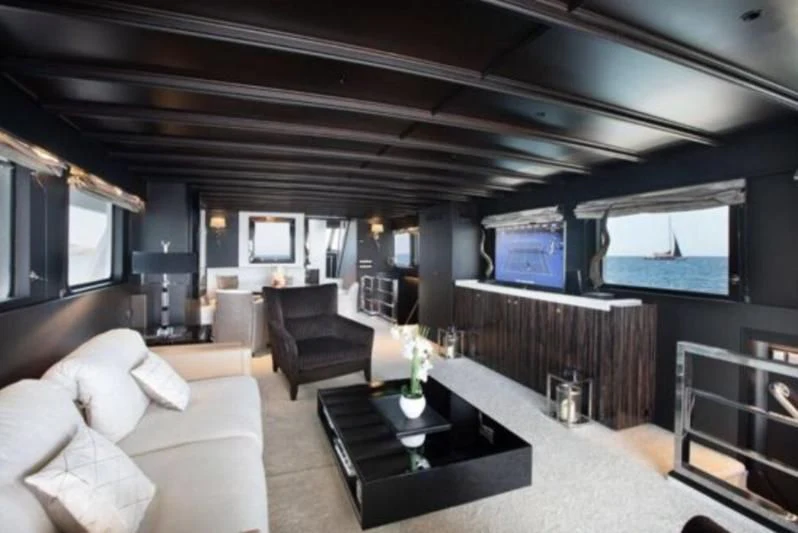 a living room with a large screen aboard RA Yacht for Sale