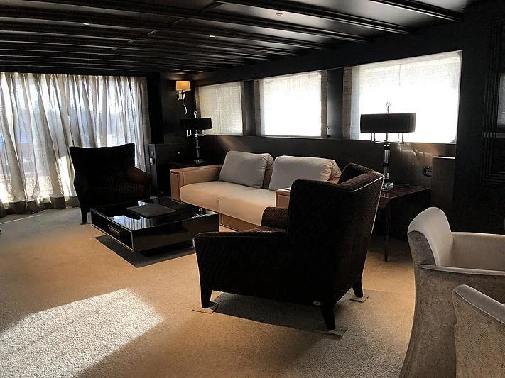 a living room with a couch and a coffee table aboard RA Yacht for Sale