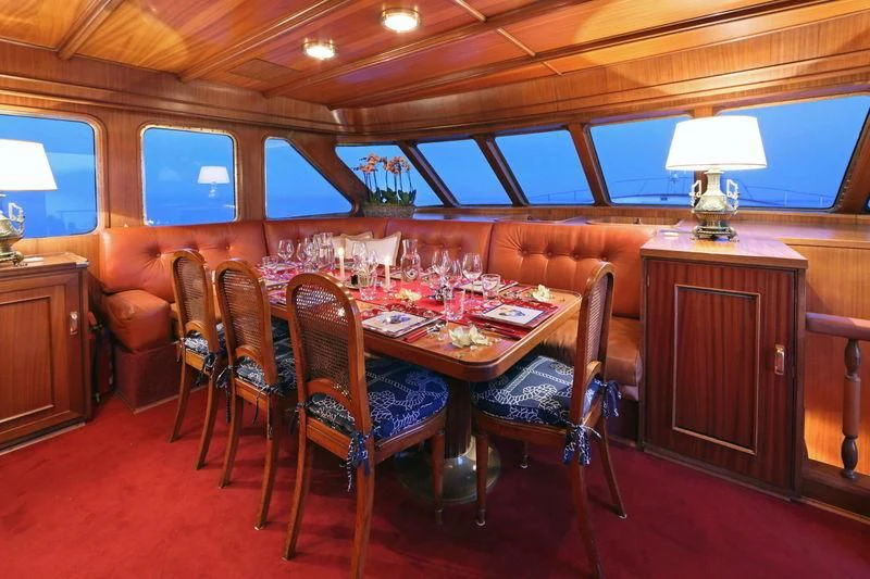 a dining room with a table and chairs aboard RA Yacht for Sale