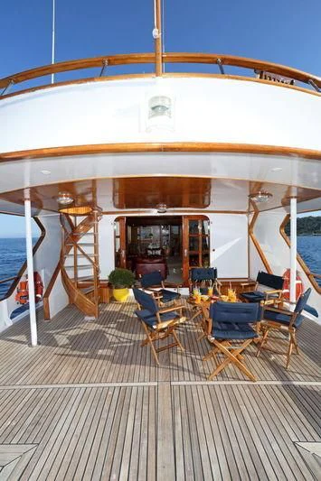 a large white building with chairs and tables aboard RA Yacht for Sale
