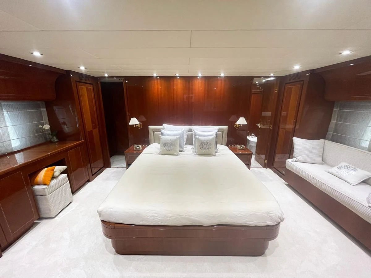 a room with a bed and a desk aboard NAISCA IV Yacht for Sale