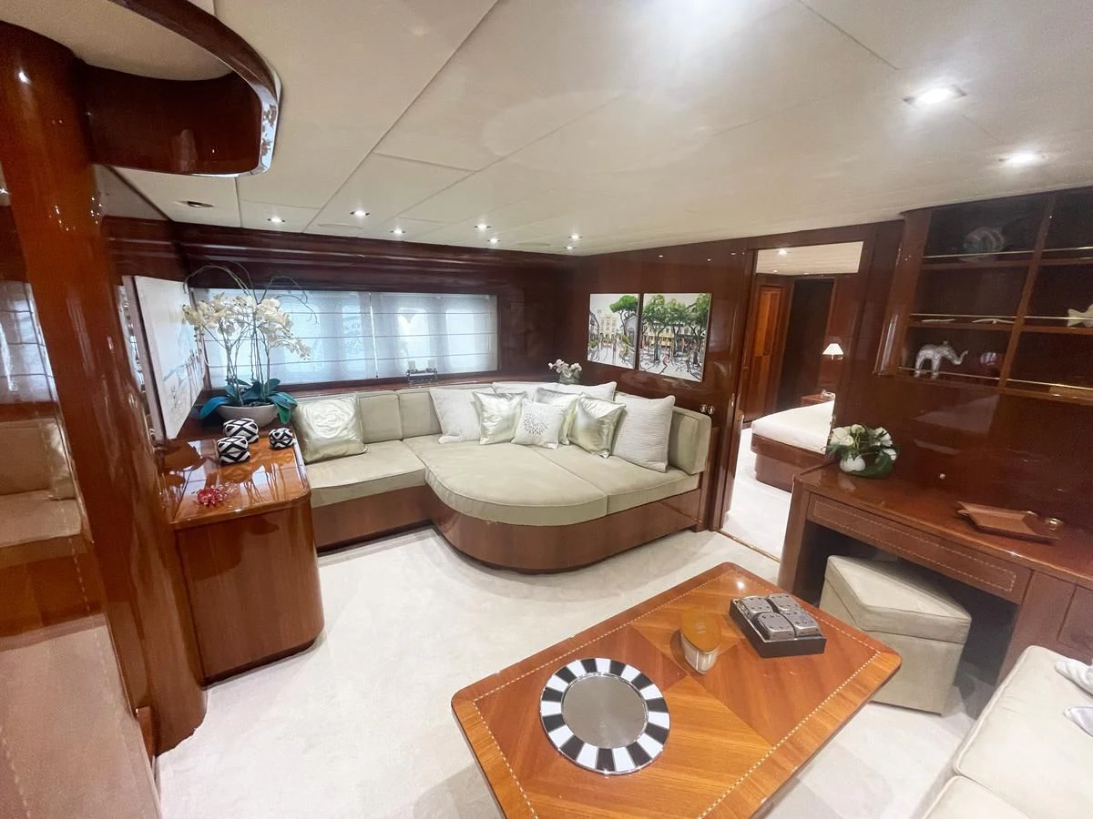 a living room with a couch and a coffee table aboard NAISCA IV Yacht for Sale