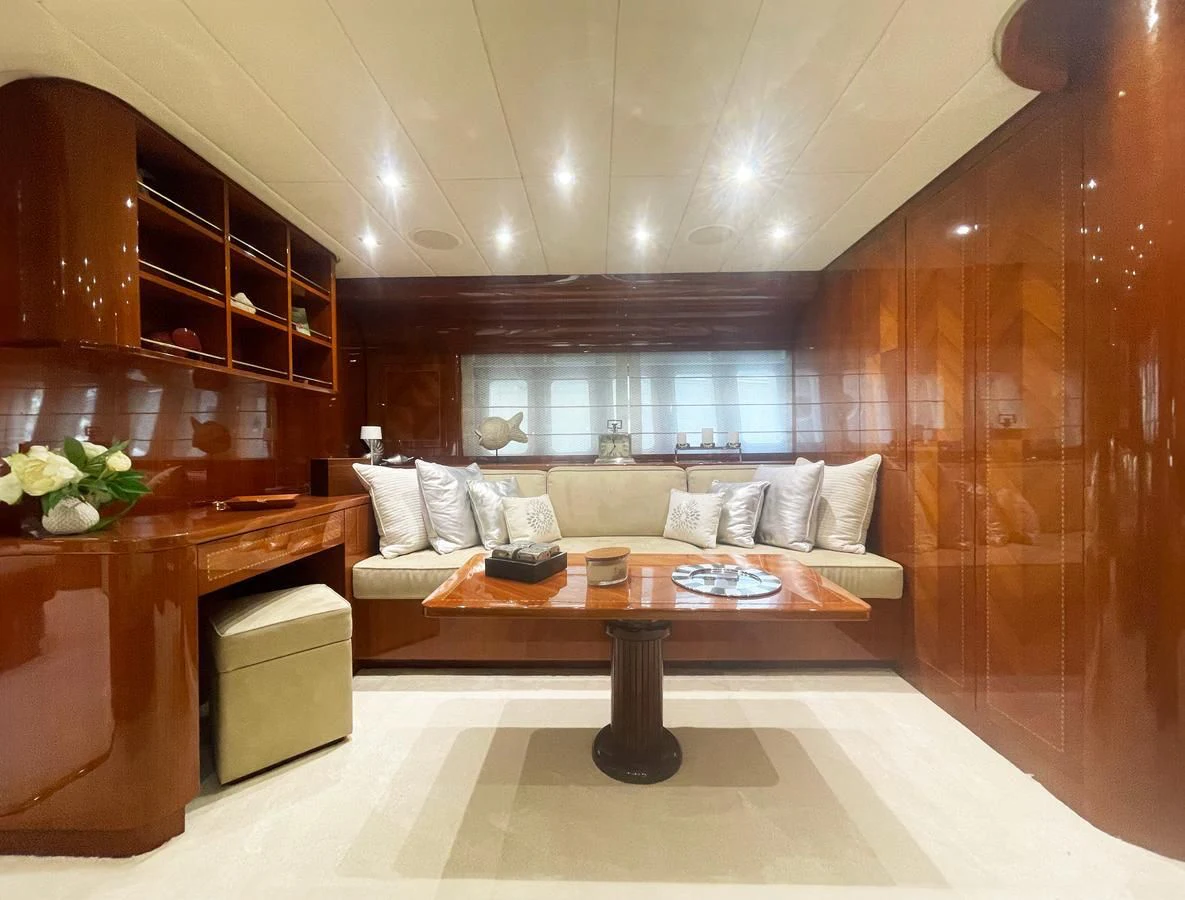 a room with a couch and a table aboard NAISCA IV Yacht for Sale