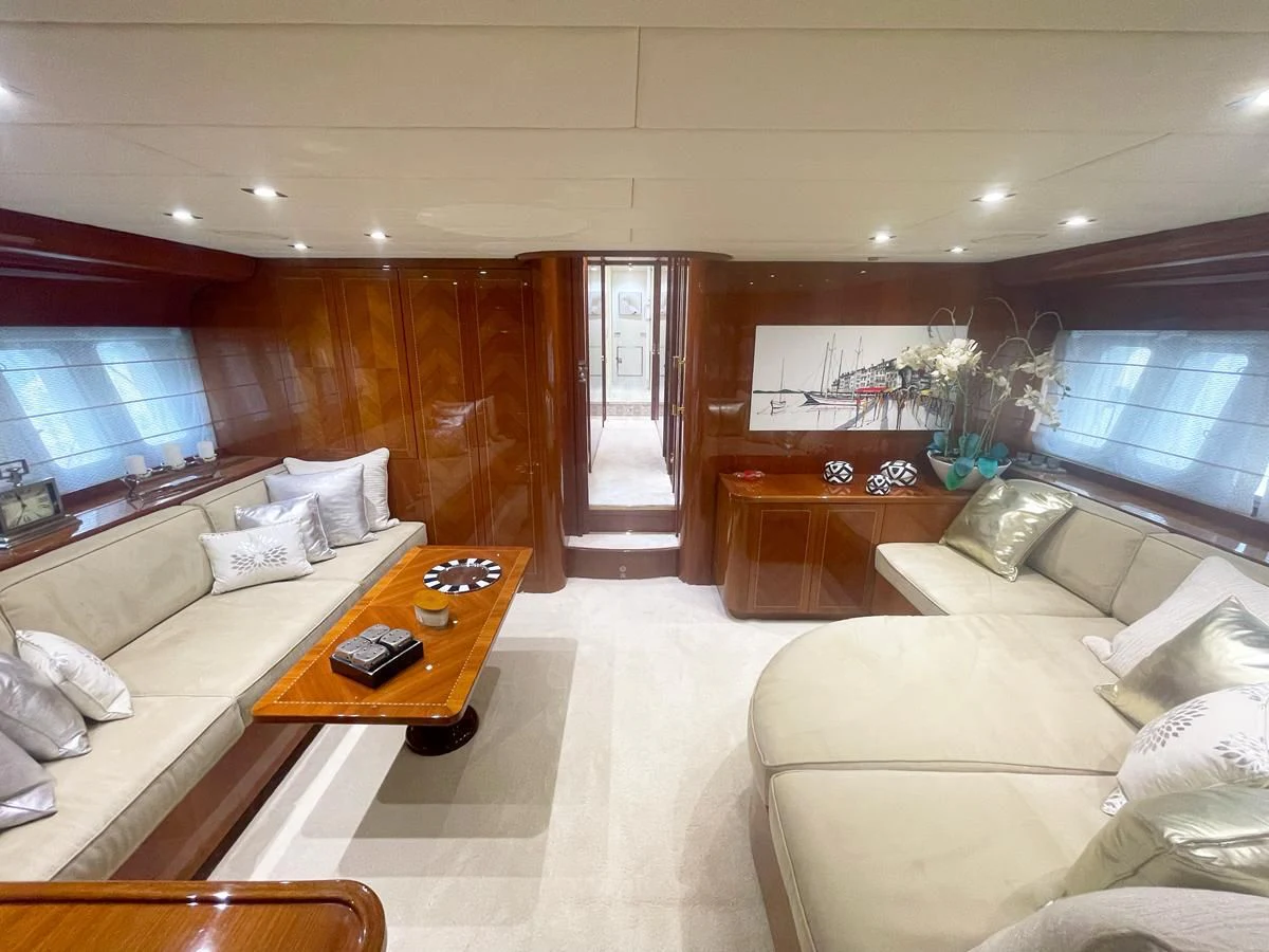a living room with a couch and a coffee table aboard NAISCA IV Yacht for Sale