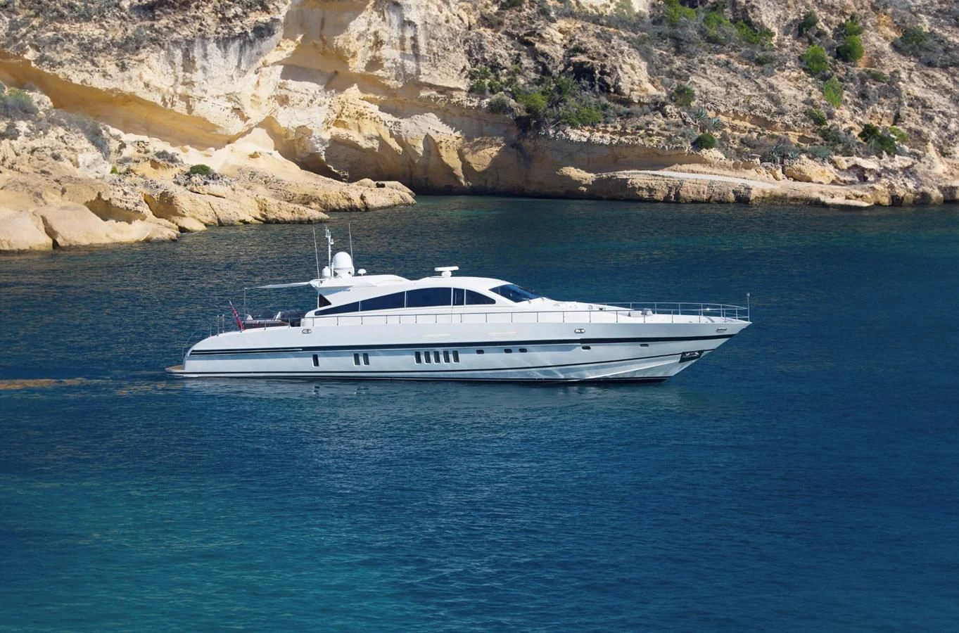 a white boat on the water aboard NAISCA IV Yacht for Sale