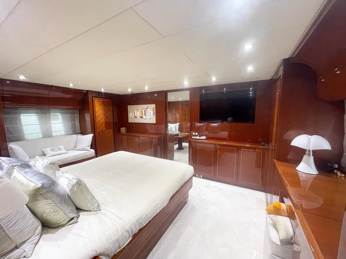a room with a bed and a television aboard NAISCA IV Yacht for Sale