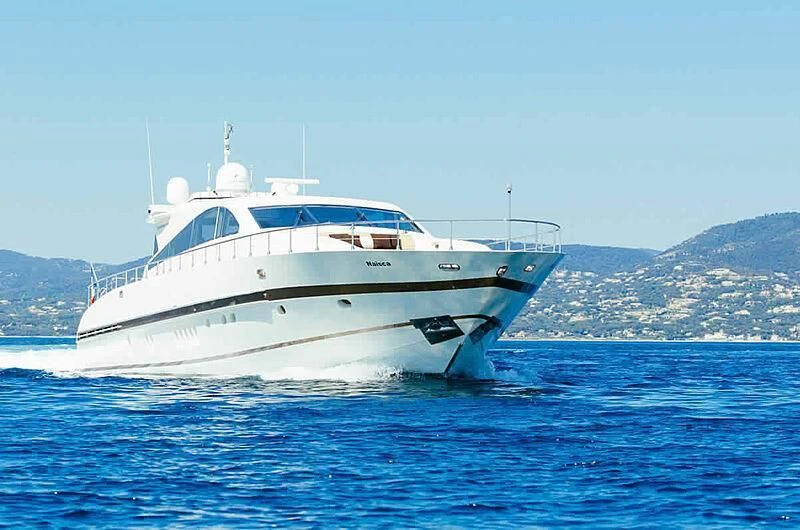 a white yacht in the water aboard NAISCA IV Yacht for Sale