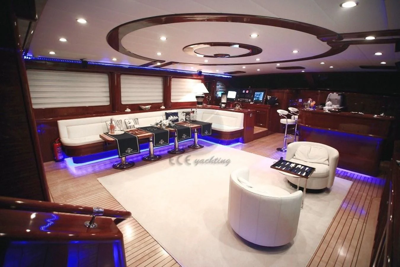 a room with a large table and chairs aboard PERFORMANCE FEE Yacht for Sale