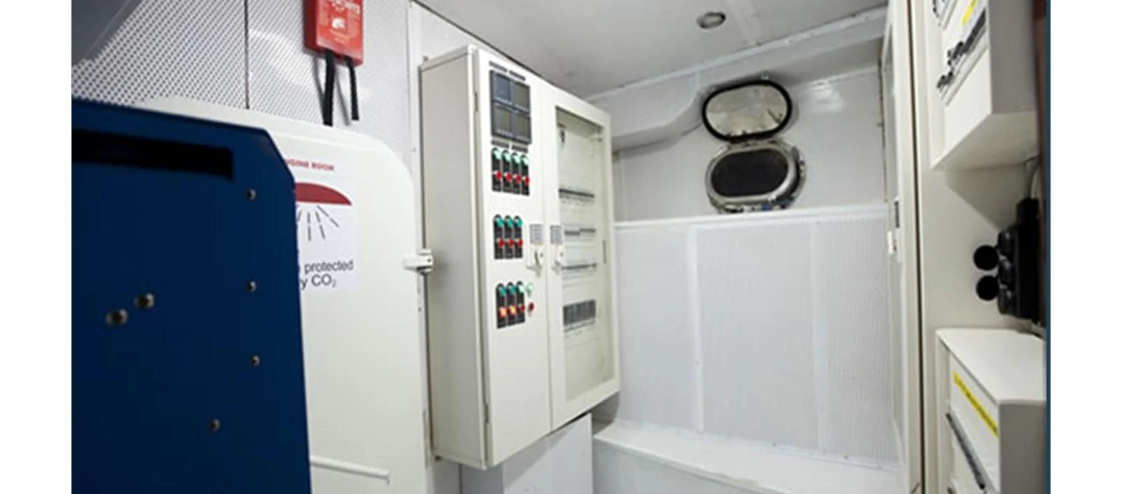 a white machine with a blue door aboard PERFORMANCE FEE Yacht for Sale