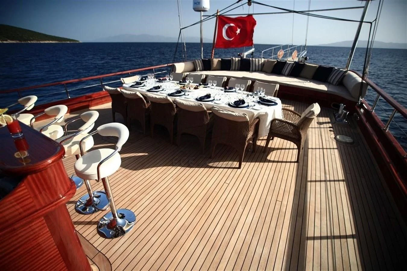 a deck with tables and chairs on it aboard PERFORMANCE FEE Yacht for Sale