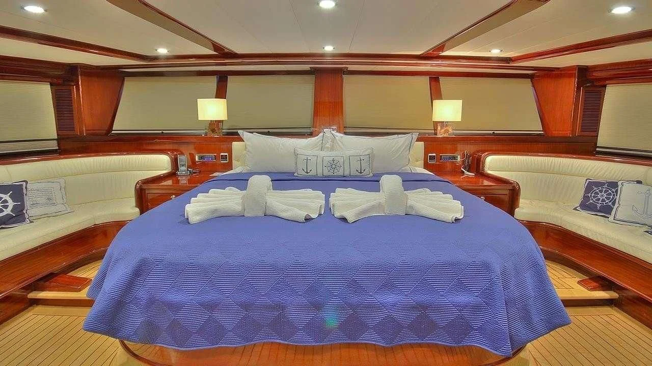a room with a bed and a lamp aboard PERFORMANCE FEE Yacht for Sale