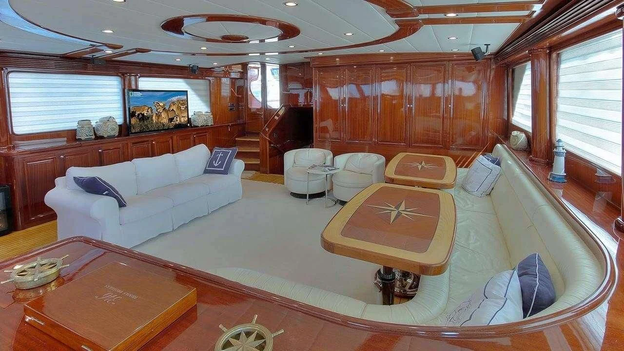 a living room with a large sofa aboard PERFORMANCE FEE Yacht for Sale