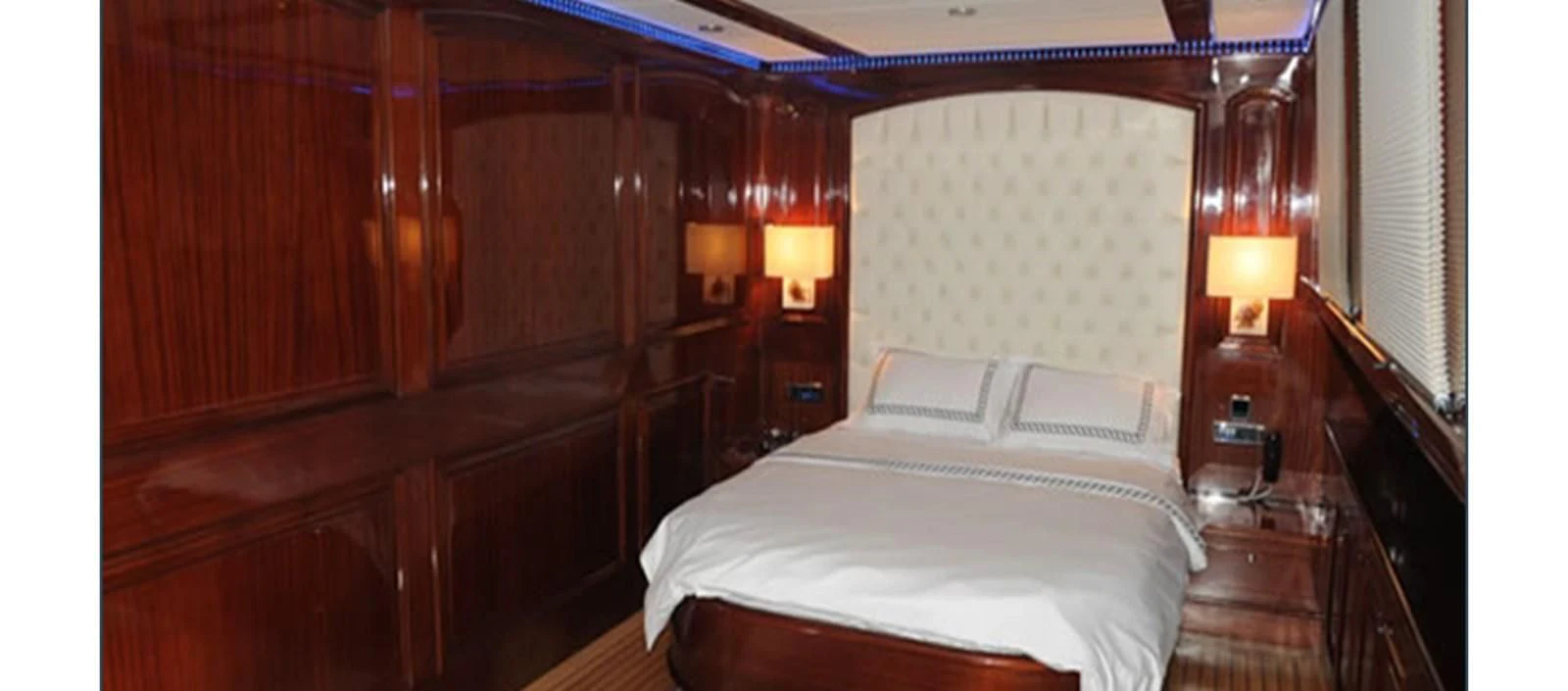 a room with a bed and a lamp aboard PERFORMANCE FEE Yacht for Sale