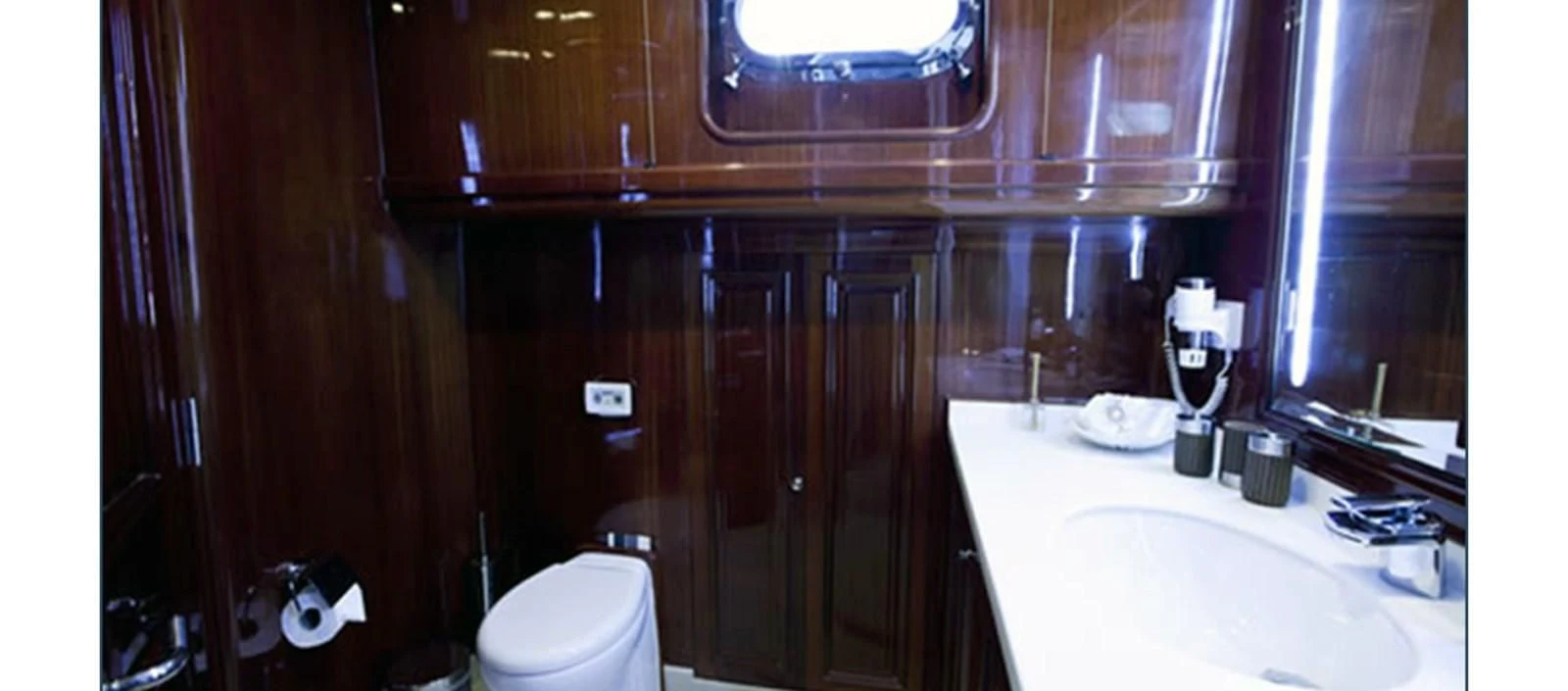 a bathroom with wooden cabinets aboard PERFORMANCE FEE Yacht for Sale