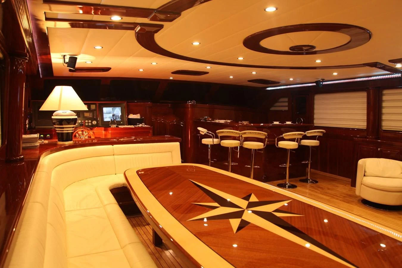 a room with a large table and chairs aboard PERFORMANCE FEE Yacht for Sale