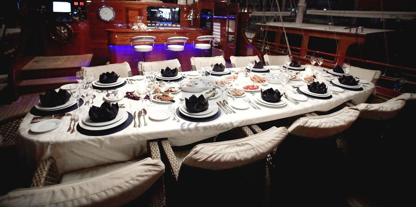 a table with plates and cups on it aboard PERFORMANCE FEE Yacht for Sale