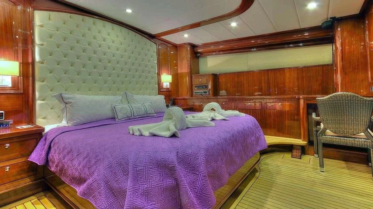 a person lying on a bed aboard PERFORMANCE FEE Yacht for Sale
