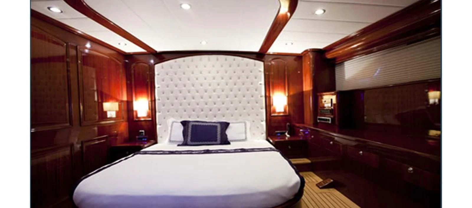 a room with a bed and a laptop on a table aboard PERFORMANCE FEE Yacht for Sale