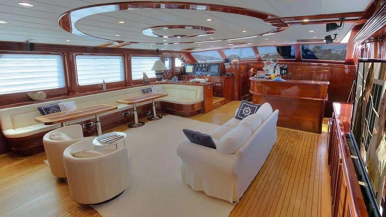 a room with a couch and a table aboard PERFORMANCE FEE Yacht for Sale