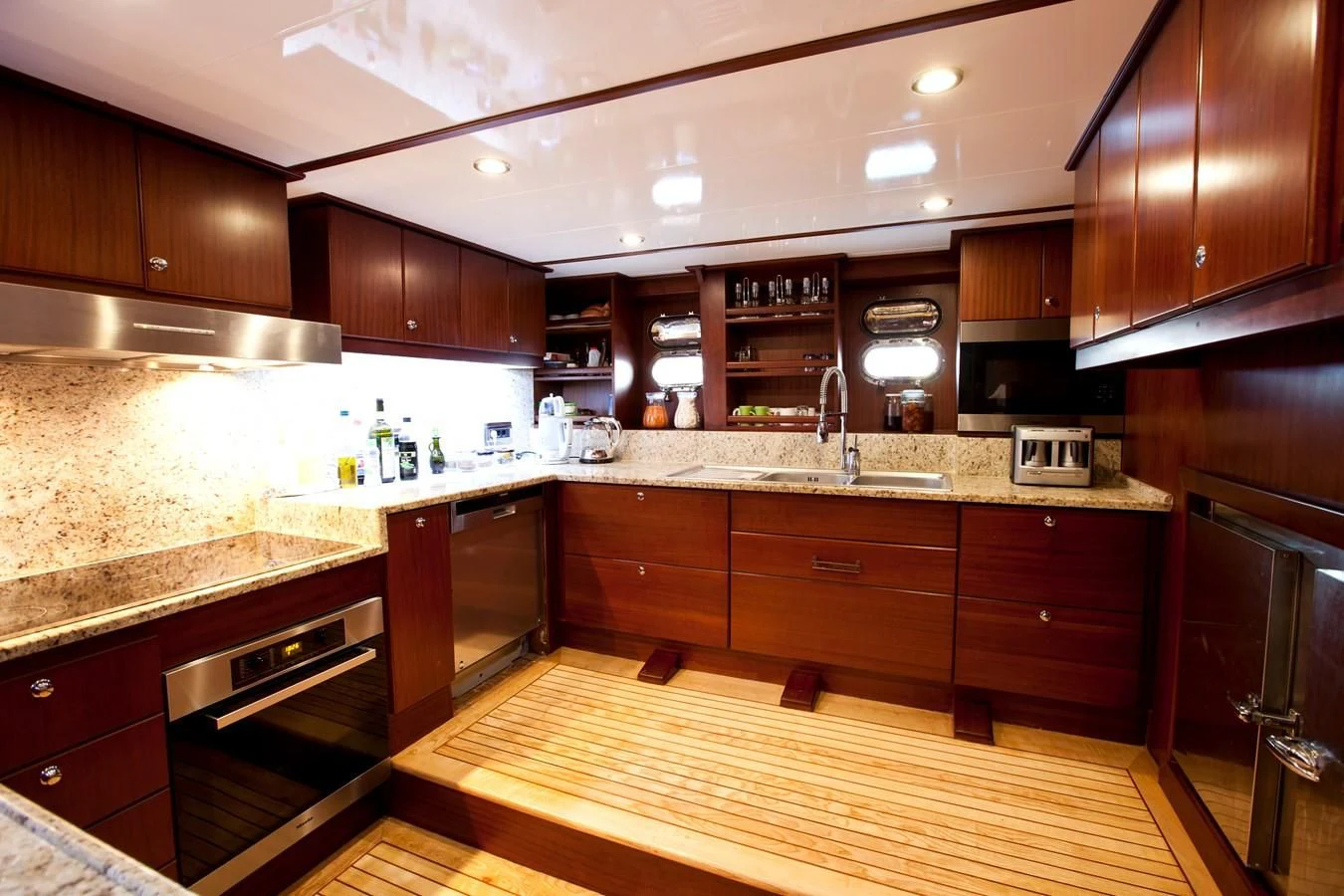 a kitchen with wooden cabinets aboard PERFORMANCE FEE Yacht for Sale