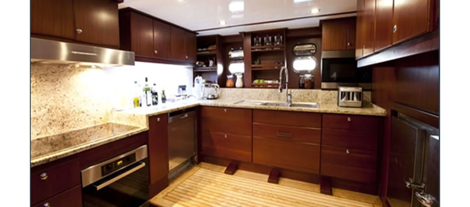 a kitchen with wooden cabinets aboard PERFORMANCE FEE Yacht for Sale