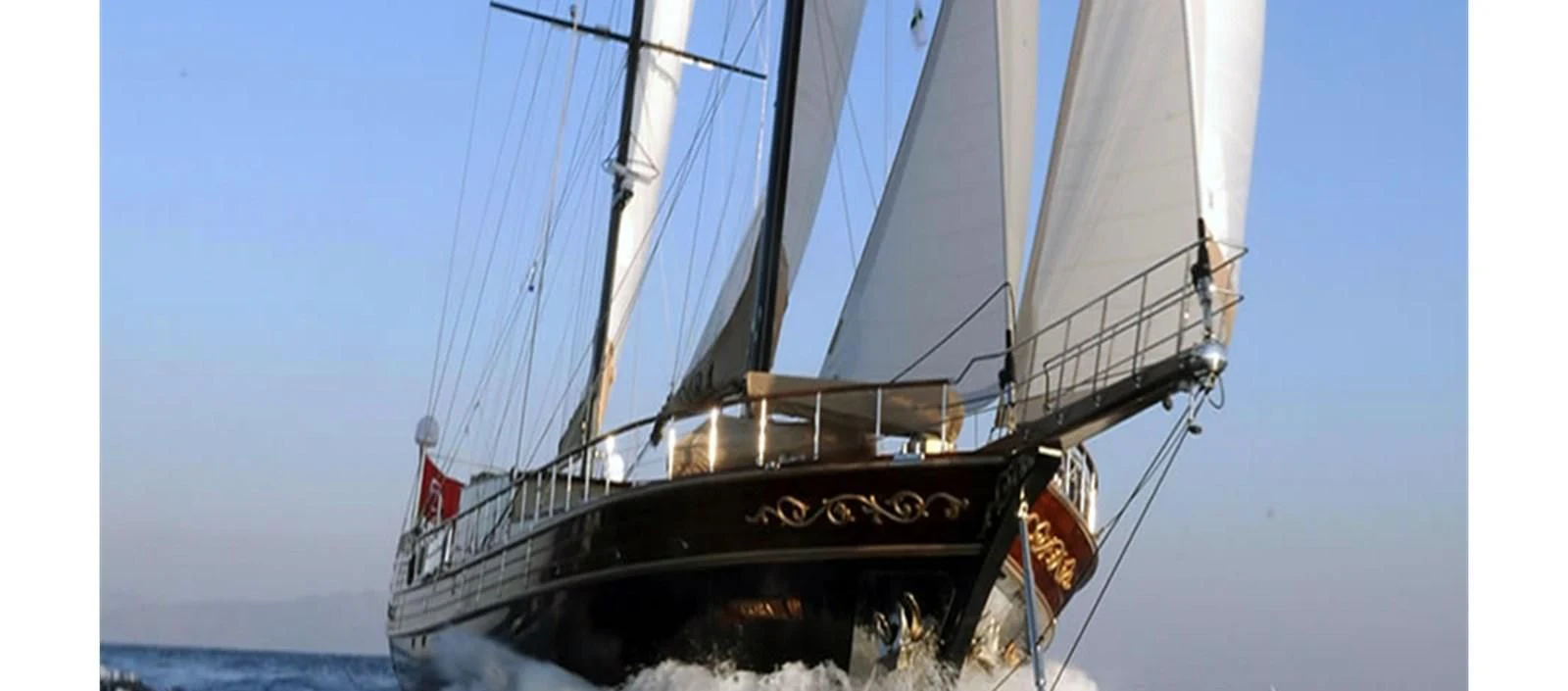 a large boat on a body of water aboard PERFORMANCE FEE Yacht for Sale